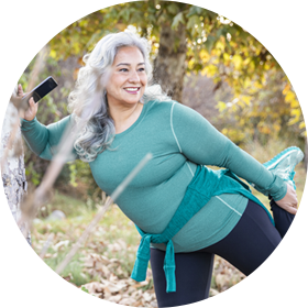 A senior Mexican woman stretching her legs.